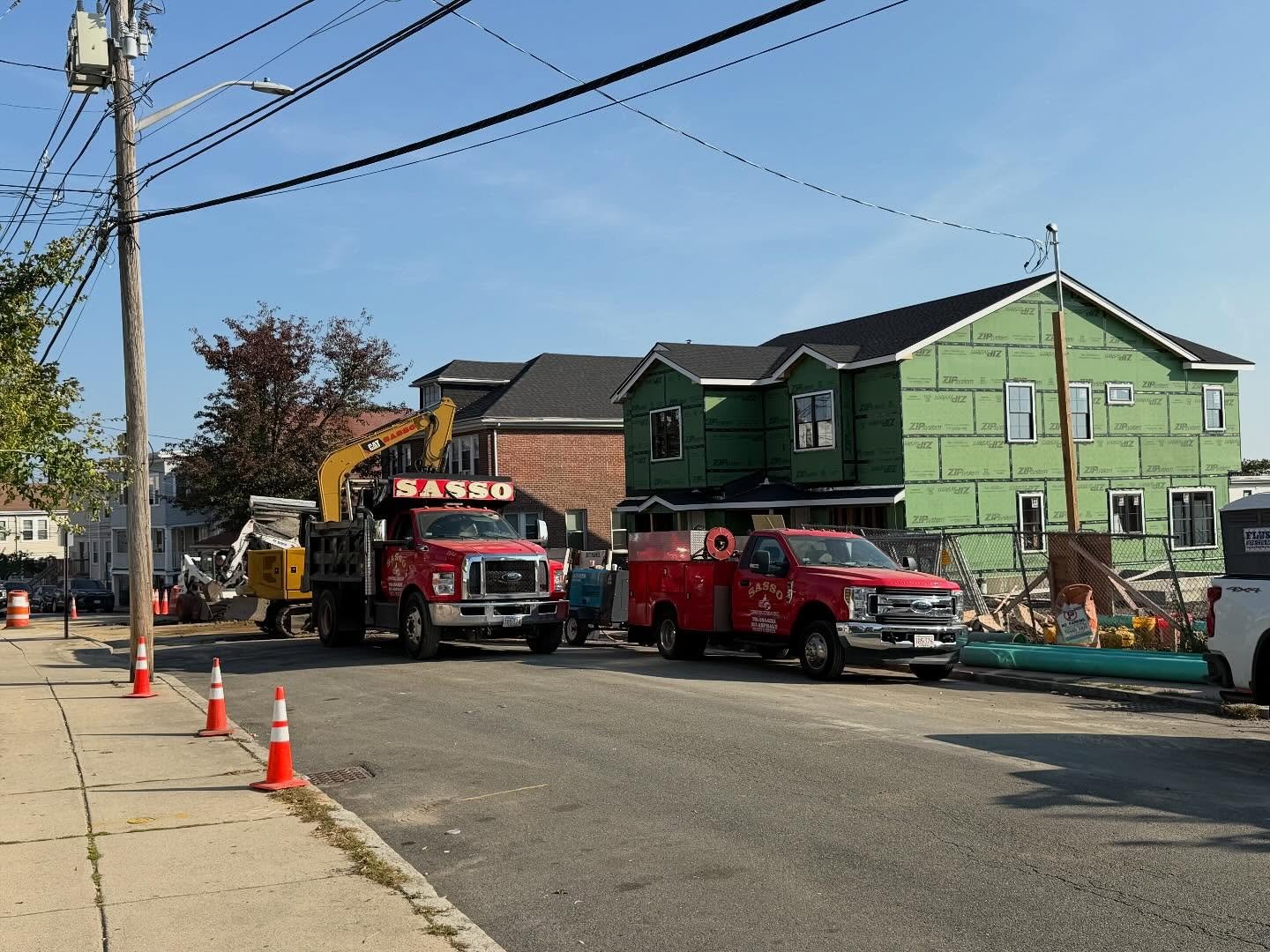 Sasso trucks and excavator at a residential construction site